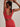 Back view of the Varley FreeSoft Cori Bra in Pink Begonia, showing wide straps and a scoop back as the model stretches.
