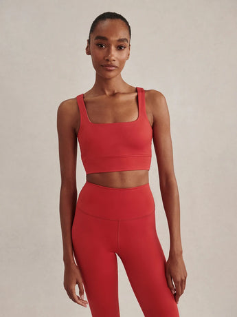 Front view of the Varley FreeSoft Cori Bra in Pink Begonia, showing the square neckline, wide straps and broad underband.