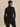Front view of the black Varley Anset Jacket, showing the tied waist, high collar and side pockets.