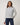 TravisMathew Soft Quilted Full Zip Jacket in Heather Light Grey, front view on model with zipper closed.