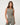 TravisMathew Pulse Tank in Olive Smoke, front view showing ribbed texture, scoop neckline and fitted cropped silhouette.