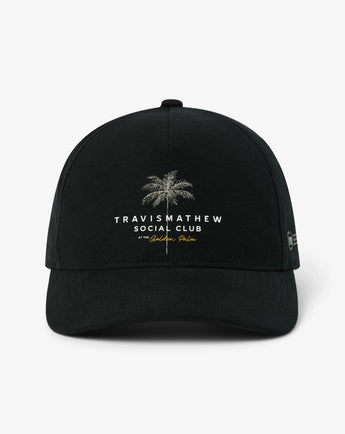 Front view of the TravisMathew Golden Horizon Snapback Hat in Black with embroidered palm tree and Social Club lettering.