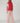 Back view of the Varley Lilah Cord Puffer Gilet in Pink Begonia, showing its padded panels and raised collar.