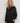 Front view of the Varley Macie Zip Hem Sweat in Black, showing its wrap collar, relaxed fit and side zip detail.