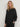 Front view of the Varley Macie Zip Hem Sweat in Black, showing its wrap collar, relaxed fit and side zip detail.