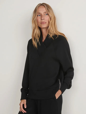 Front view of the Varley Macie Zip Hem Sweat in Black, showing its wrap collar, relaxed fit and side zip detail.