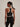 Back view of the Varley Always Jay Bra in Black/Snow White, showing its racerback silhouette and contrast piping