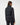 Rear view of black TravisMathew Moontide Bonded Vest 2.0 showing horizontal panels and stand collar.