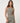 TravisMathew Pulse Tank in Olive Smoke, front view showing ribbed texture, scoop neckline and fitted cropped silhouette.