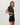 Angled front view of the Vuori Energy Classic Tee in Hemlock Heather, with the model lifting the hem slightly.
