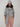 Varley Melchie Relaxed Knit Hoodie in Grey Marl styled with a matching scarf and beanie, showing its drawstring hood and textured knit.
