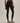 Rear view of Varley Always Contrast High Rise Legging 25 in Black/Snow White, showing the high waistband and fitted cropped legs.