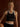 Front view of the Varley Always Jay Bra in Black/Snow White against a wood-paneled background.